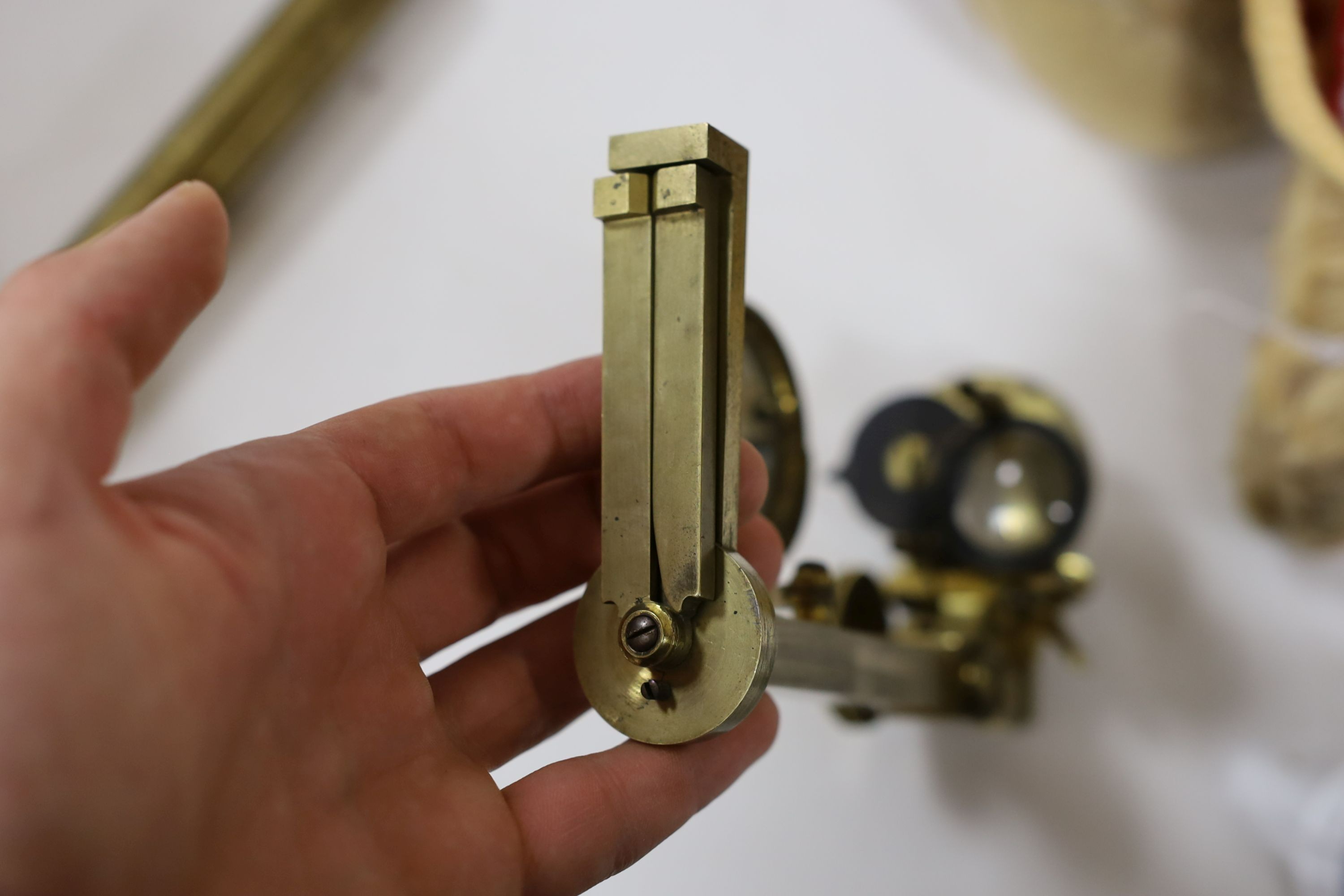 A mahogany cased microscope and a pair of Burdizzo tail dockers, 40cms long